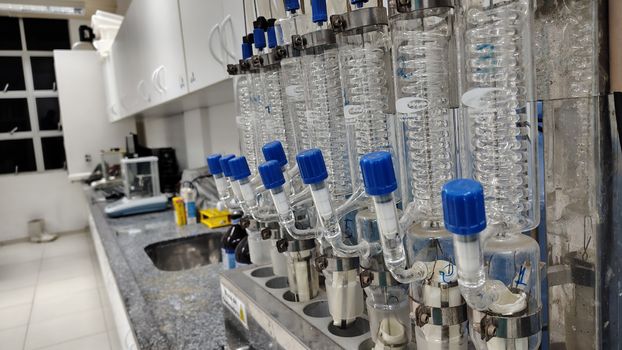 Image of a laboratory setup with glass condensers and lab equipment on the countertop.