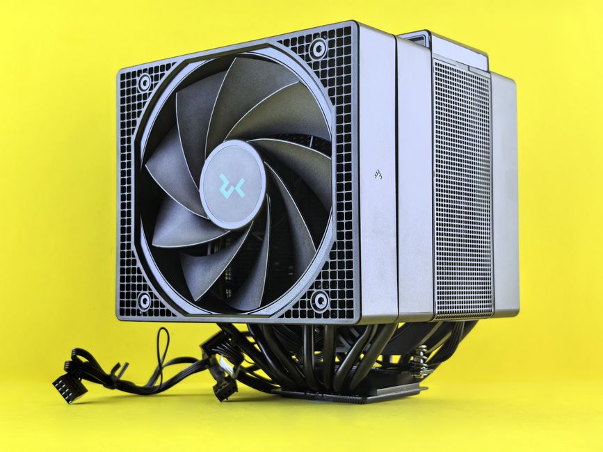 Close-up de um potente cooler de CPU com ventoinha e cabos em um fundo amarelo vibrante, destacando a tecnologia moderna.