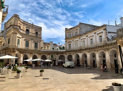 Free Explore the beautiful arches and historic architecture of Martina Franca's charming piazza. Stock Photo