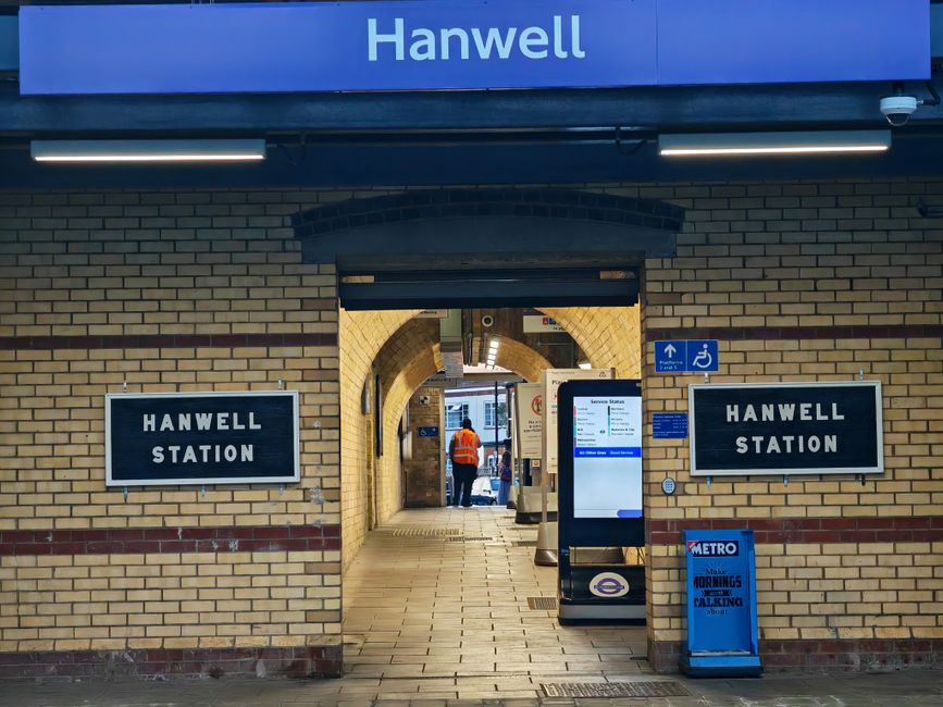 View of Hanwell Station entrance in London showing signs and architecture.