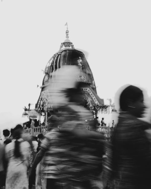Free Black and white image of a crowd in motion during a traditional Indian festival with a chariot. Stock Photo