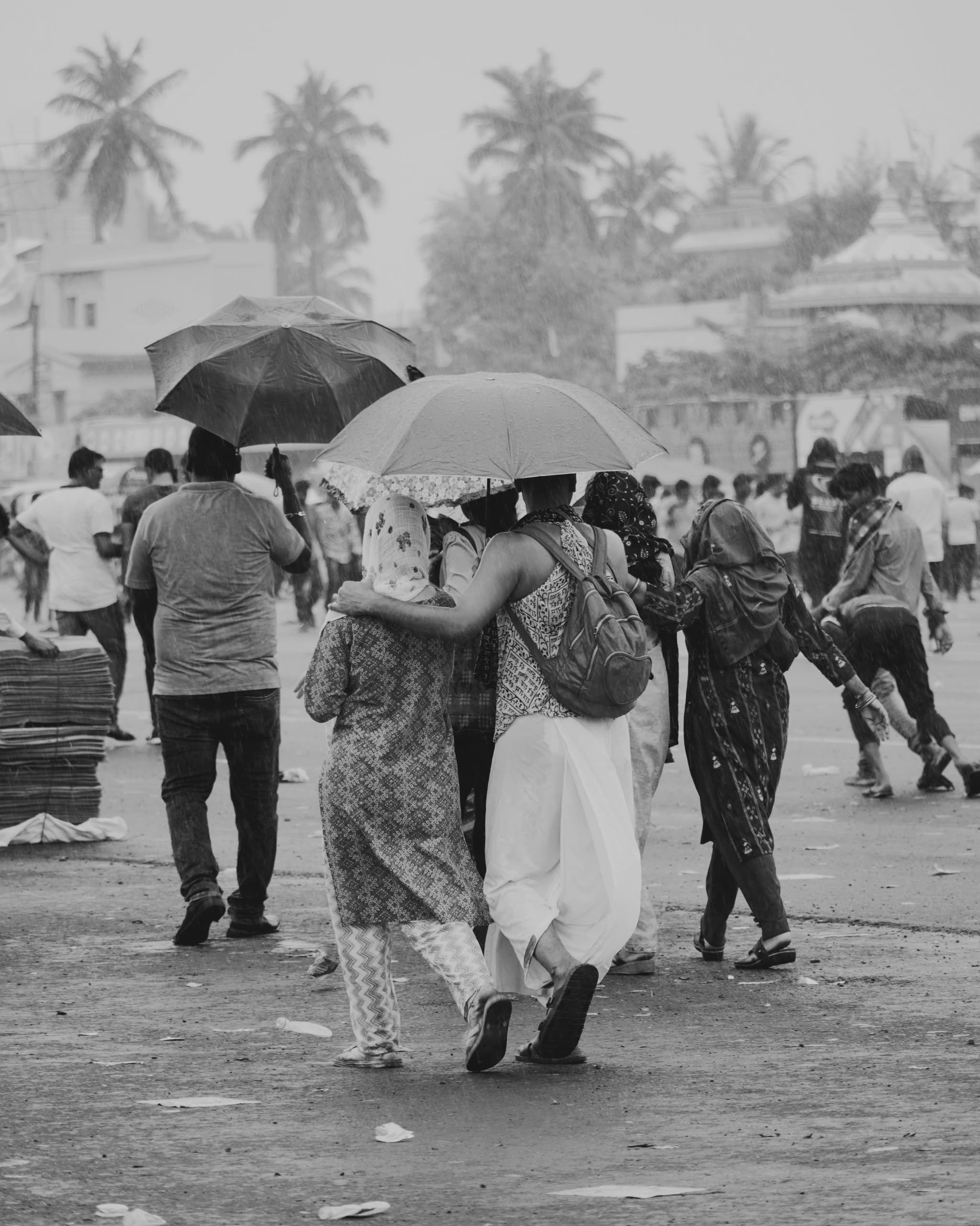 Crowded monsoon street scene with colorful umbrellas