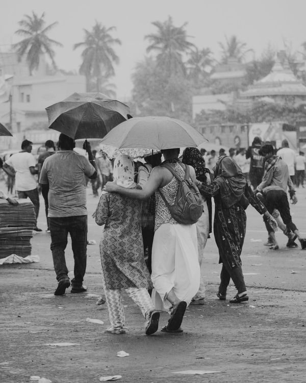 Crowded monsoon street scene with colorful umbrellas