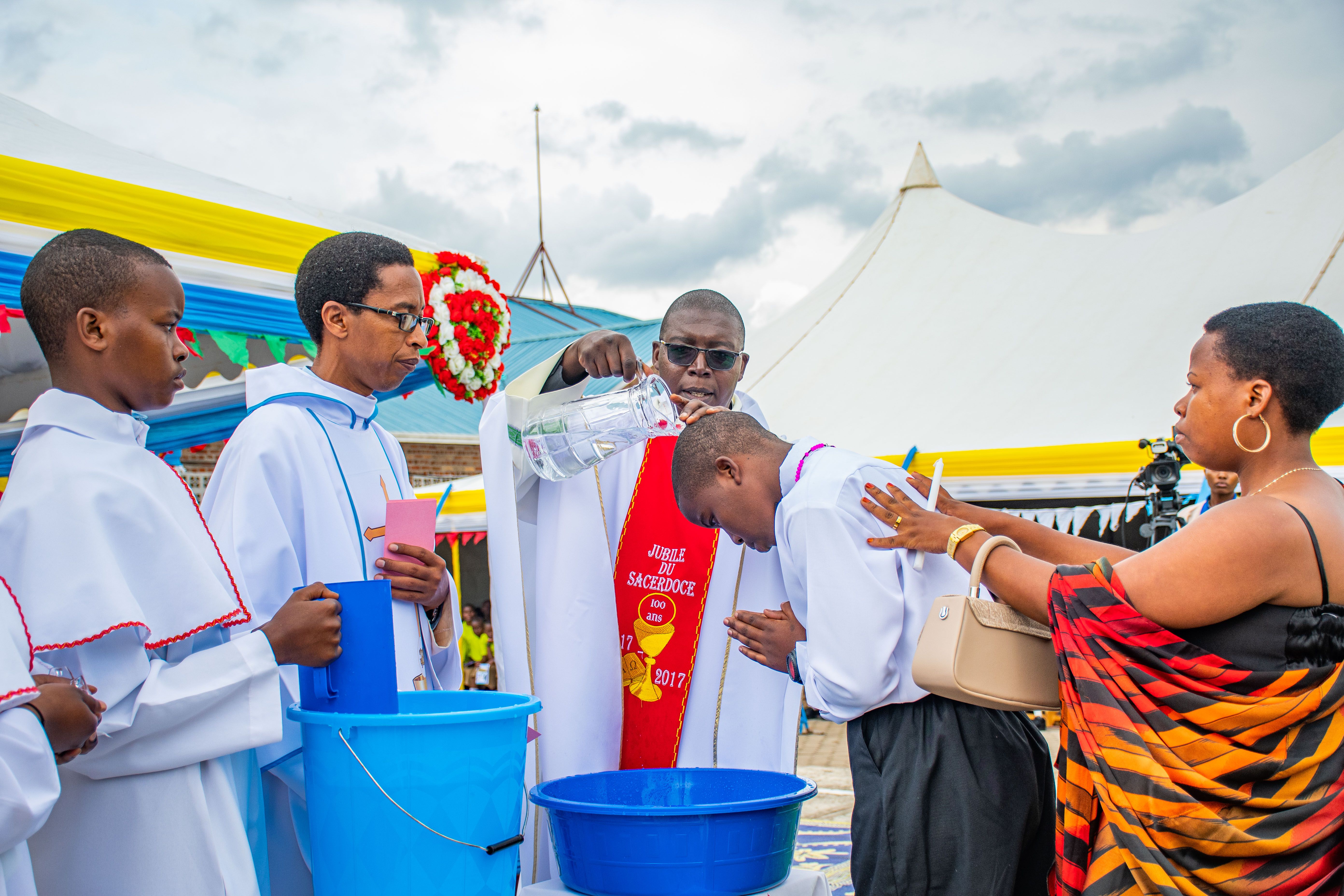 Ceremonial baptism performed by priests during an outdoor service.