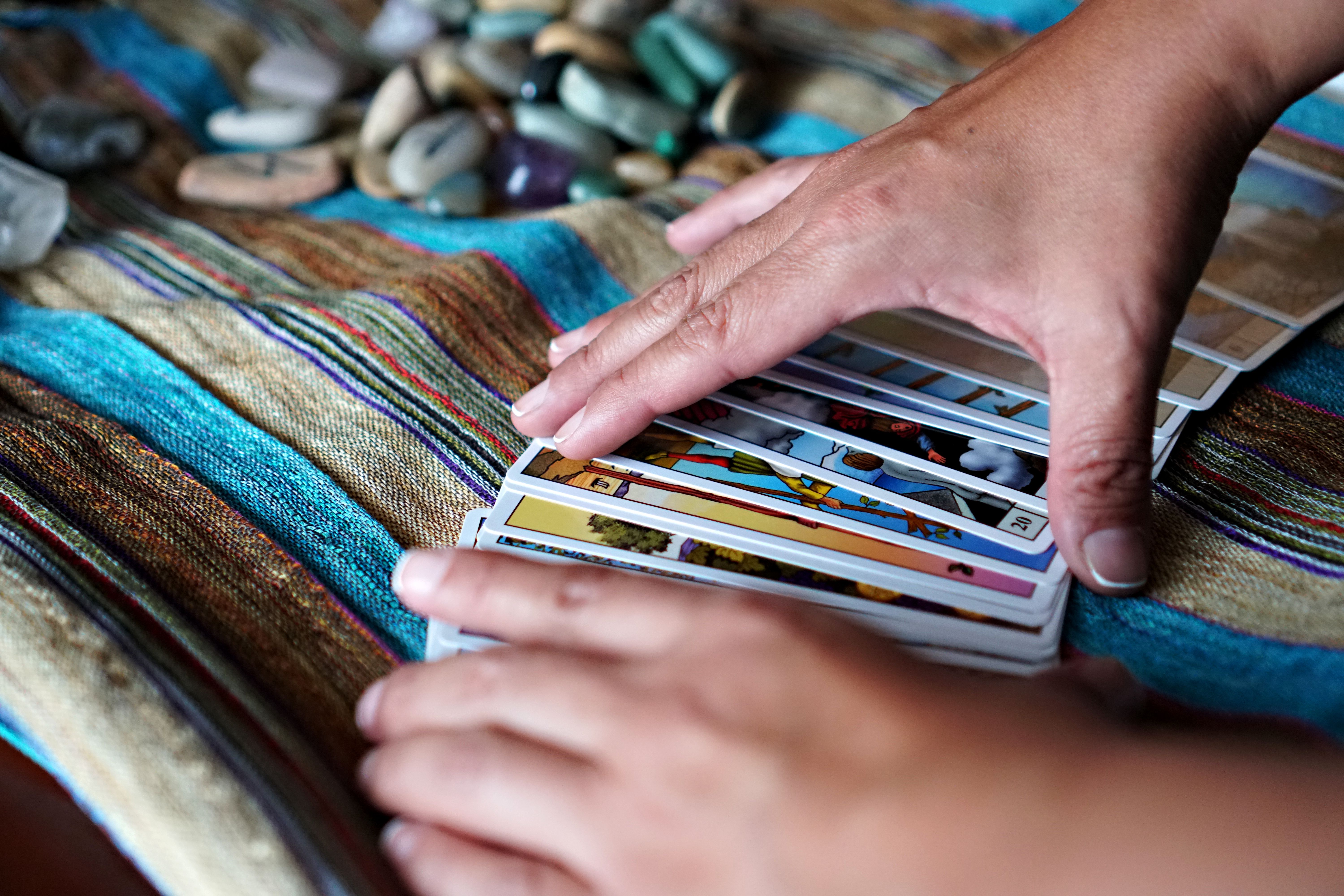 Hands Arranging Tarot Cards on Colorful Cloth · Free Stock Photo