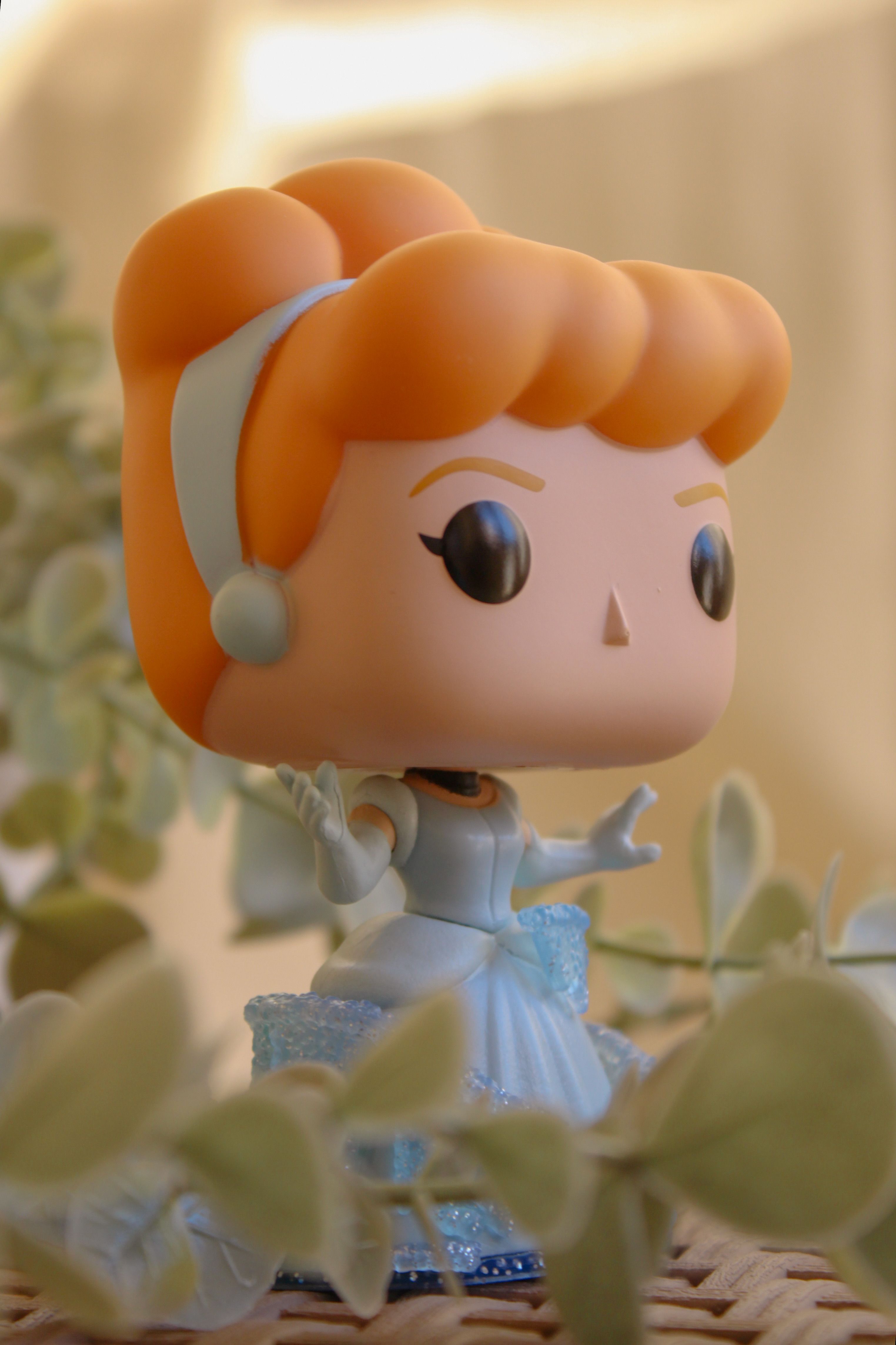 Adorable figurine with vibrant colors amidst soft natural surroundings.