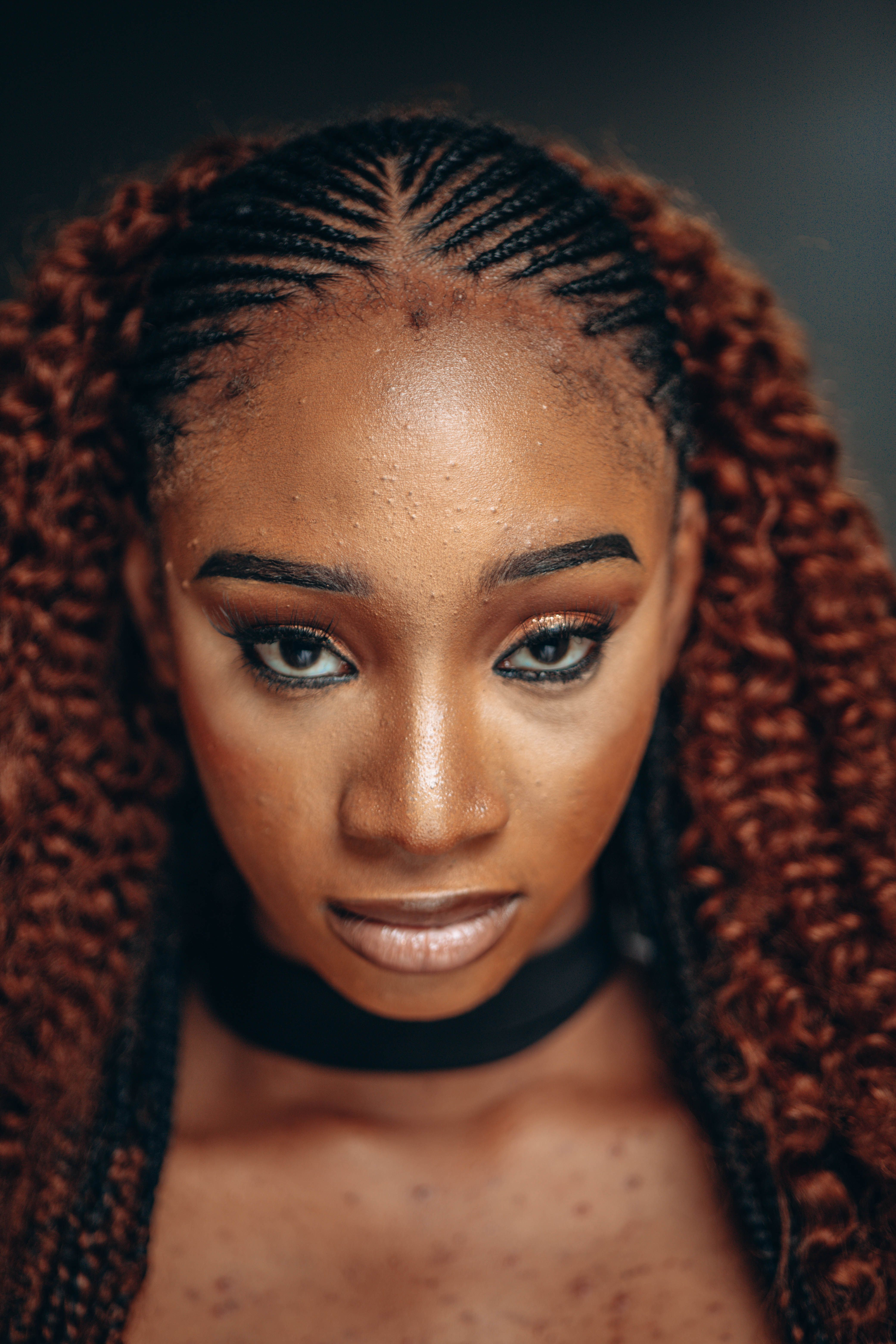 Elegant Portrait of a Woman with Braided Hairstyles · Free Stock Photo