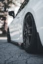 Close-up of a Sleek White Car with Black Rims