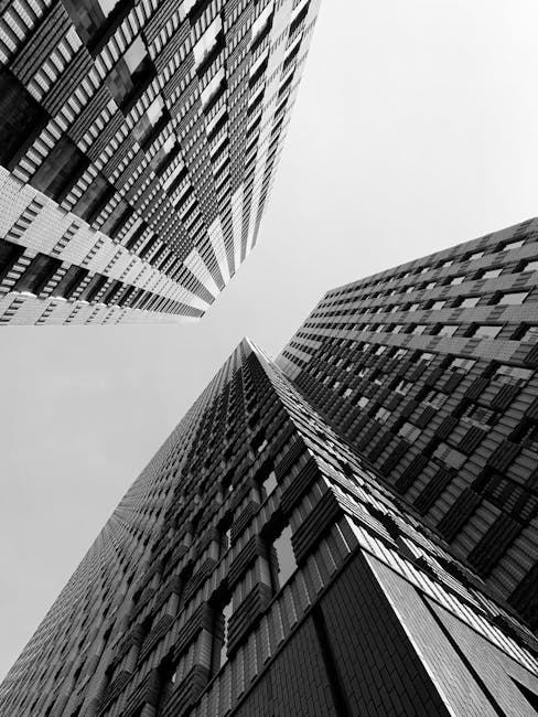 Dramatic view of modern high-rise buildings with glass facades in Amsterdam.
