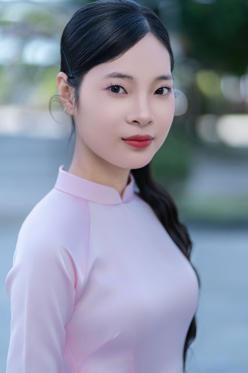 Portrait of a woman in traditional attire outdoors, exuding grace and elegance.
