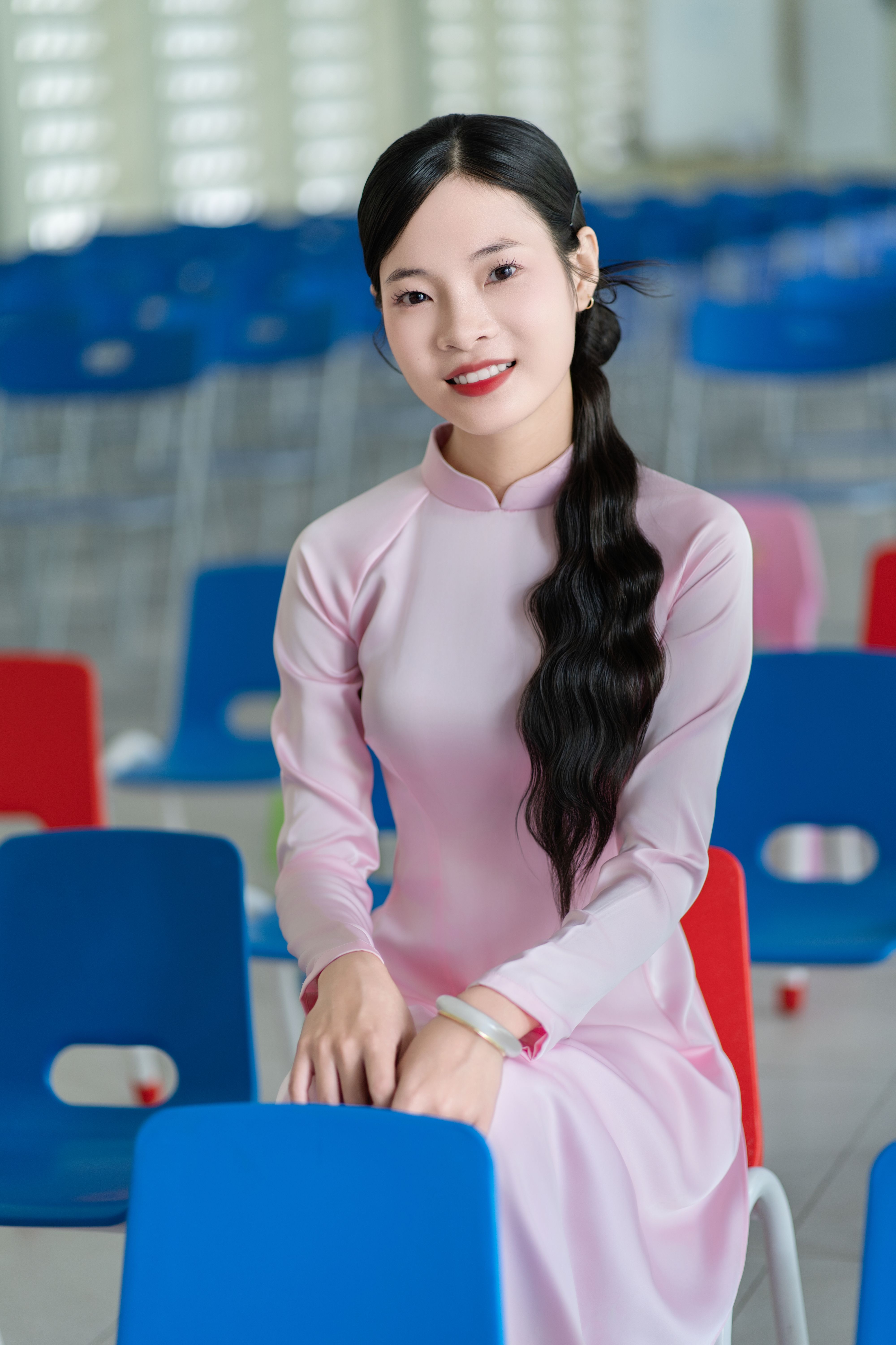 Elegant Woman in Traditional Dress Sitting Indoors · Free Stock Photo