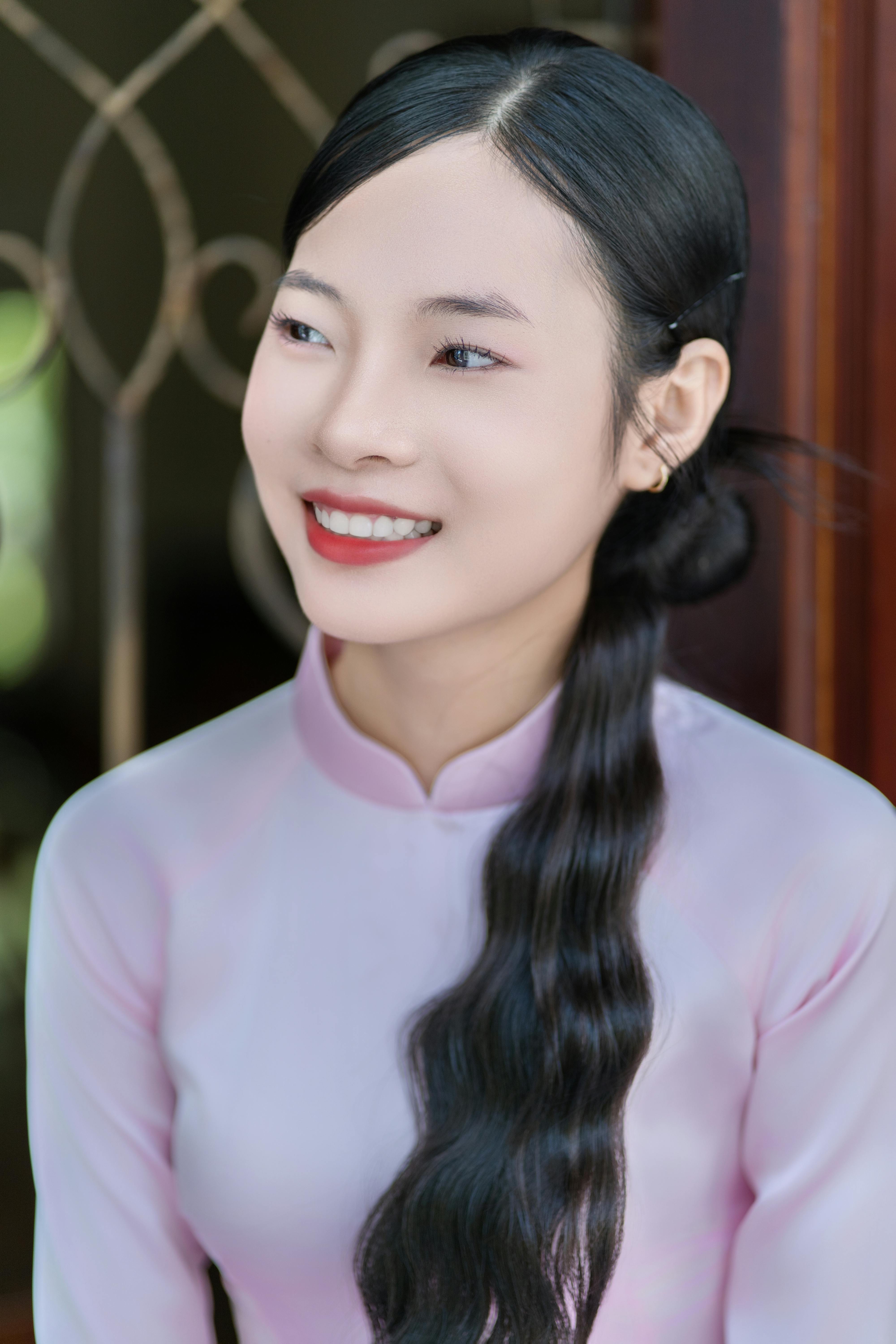 Smiling young woman in traditional garment, embodying elegance and grace.