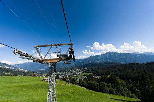 Free Breathtaking view of the Swiss Alps and cable car with lush landscapes and blue skies. Stock Photo