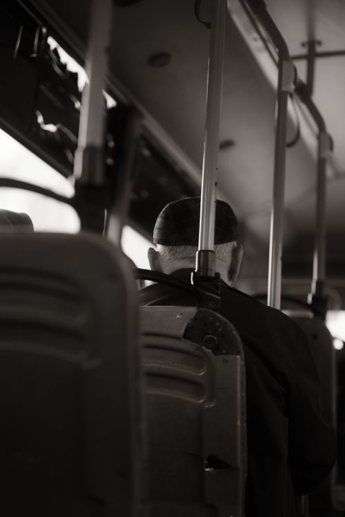 Free Black and white photo capturing a senior man seated on a bus in Degirmendere, Türkiye. Stock Photo