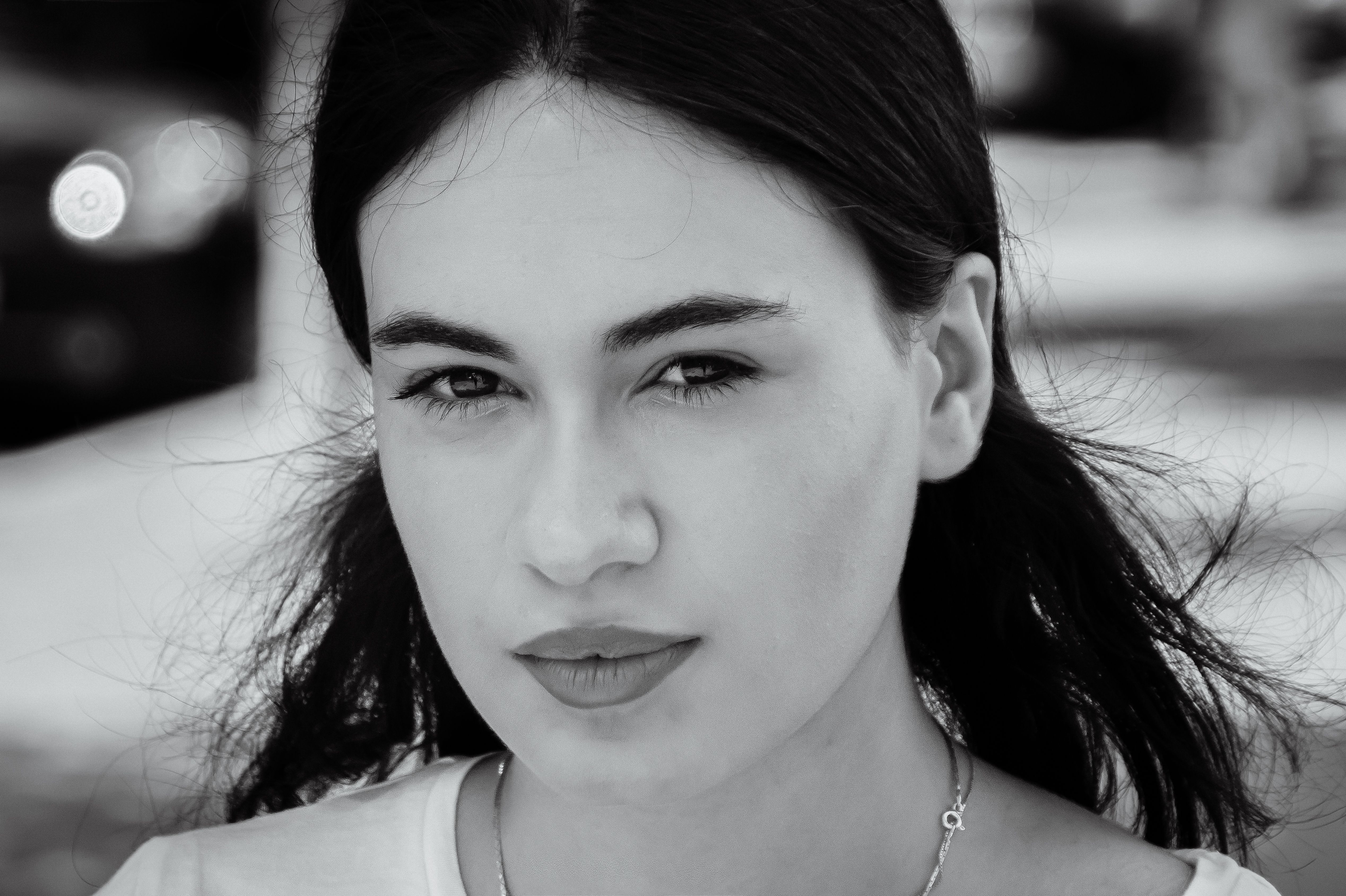Elegant black and white portrait of a woman featuring classic beauty and serene expression.