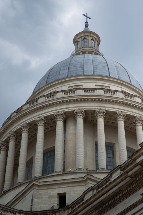 Free Stunning architectural detail of the Panthéon's dome against a cloudy Parisian sky. Stock Photo