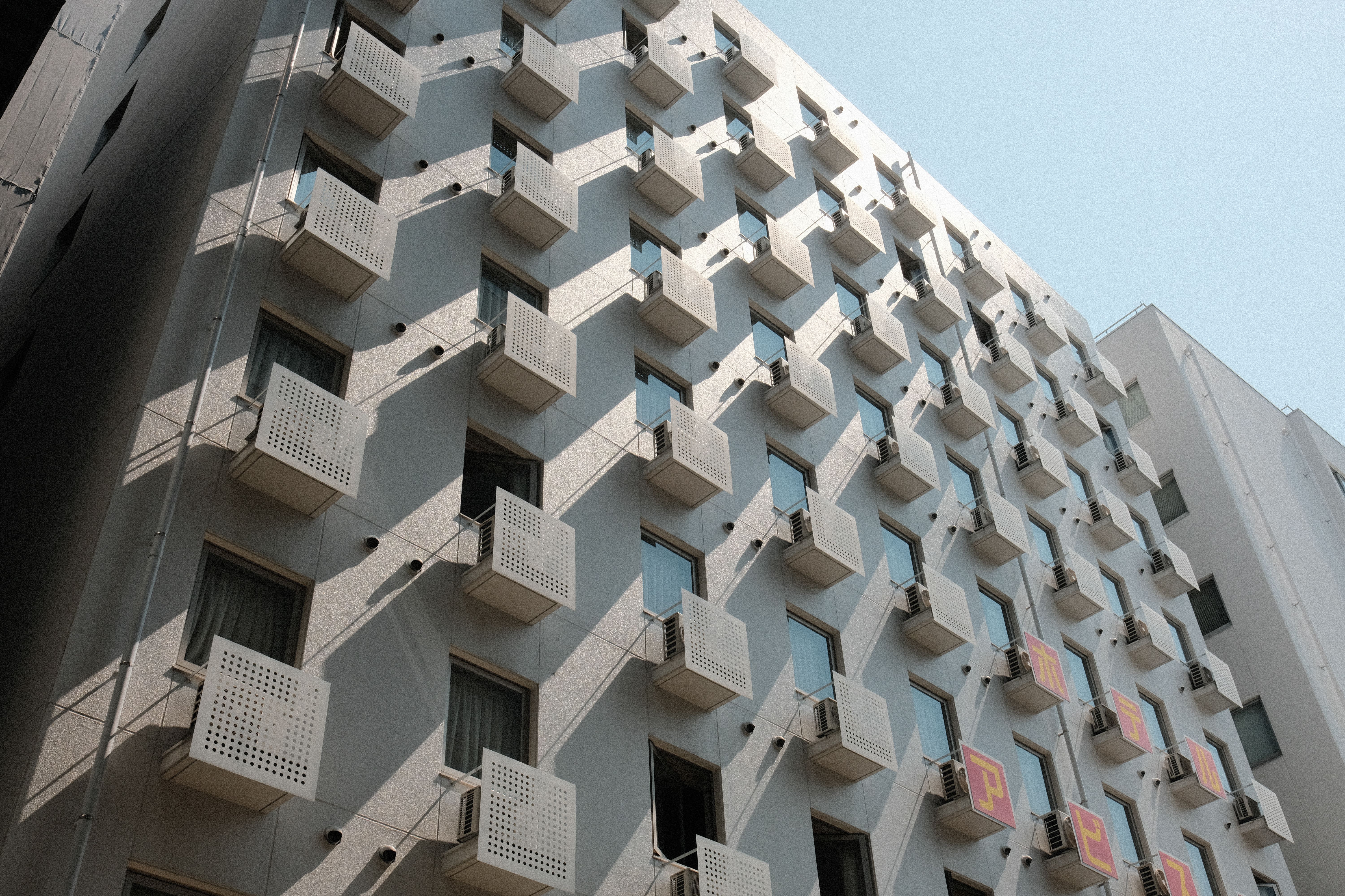Modern Apartment Building with Geometric Windows · Free Stock Photo