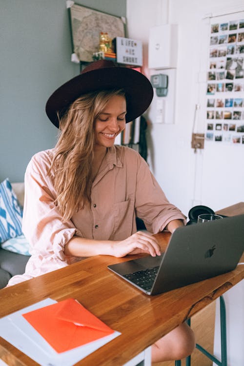 Free Smiling Woman Using Laptop Stock Photo