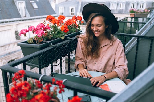 Woman Wearing Beige Dress Shirt Using Laptop Computer