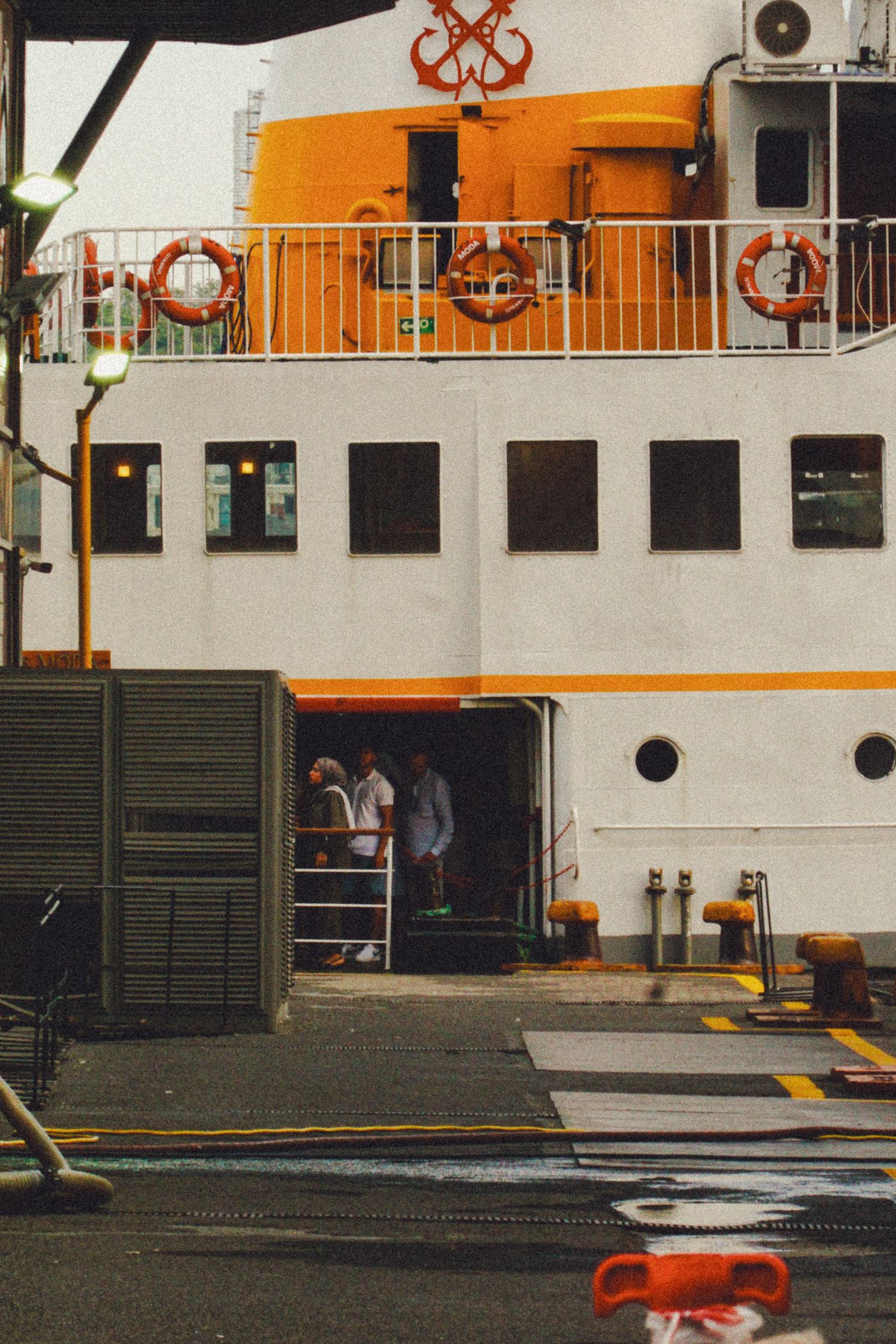 Crew members at a docked commercial vessel in port