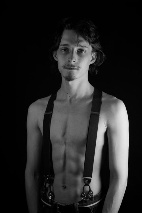 Free Classic black and white portrait of a young man in suspenders, exuding artistic elegance. Stock Photo