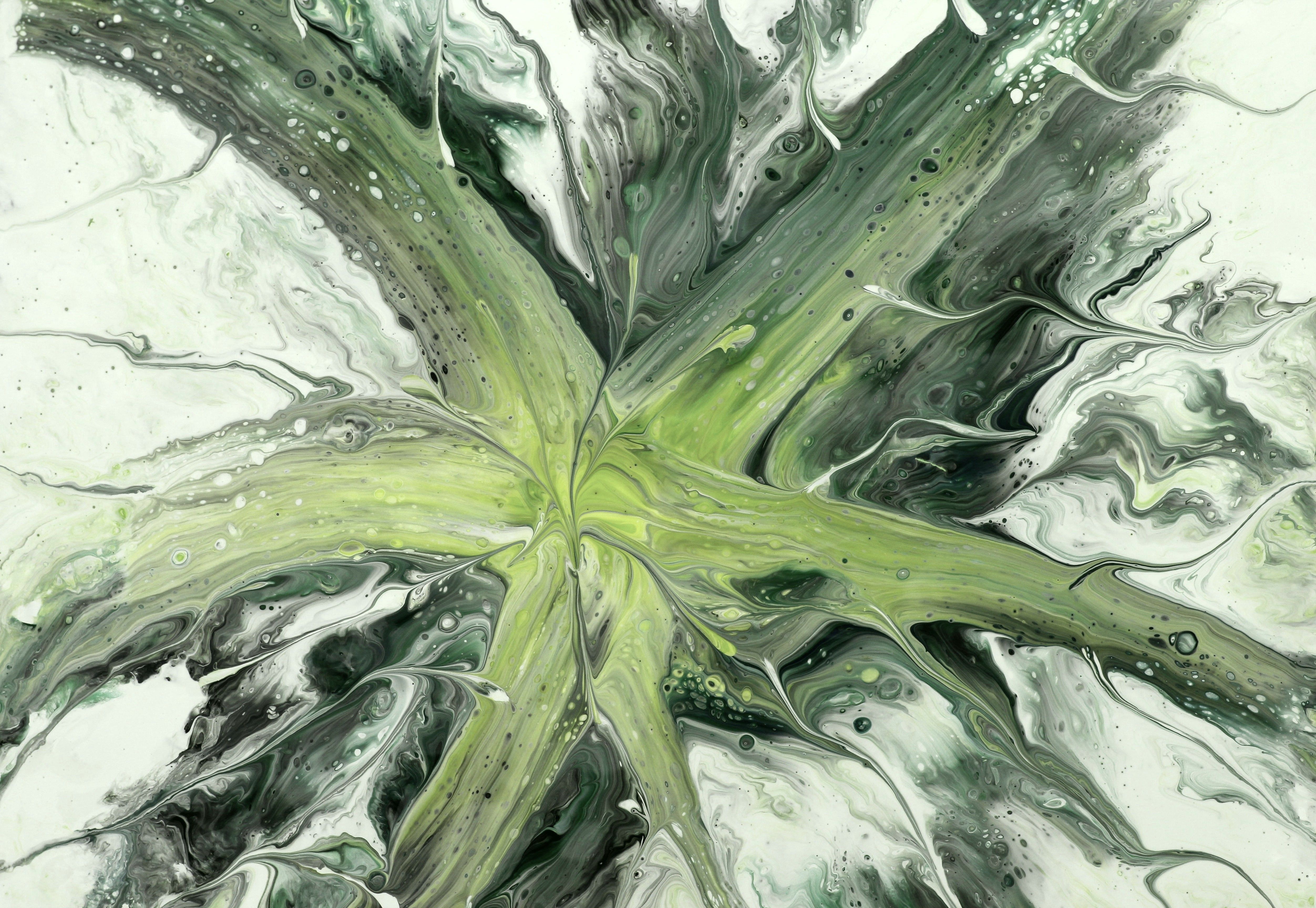 Abstract painting with green and black swirls creating a star-like shape.