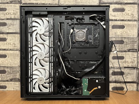 Interior view of an open computer case featuring cooling fans and wiring.