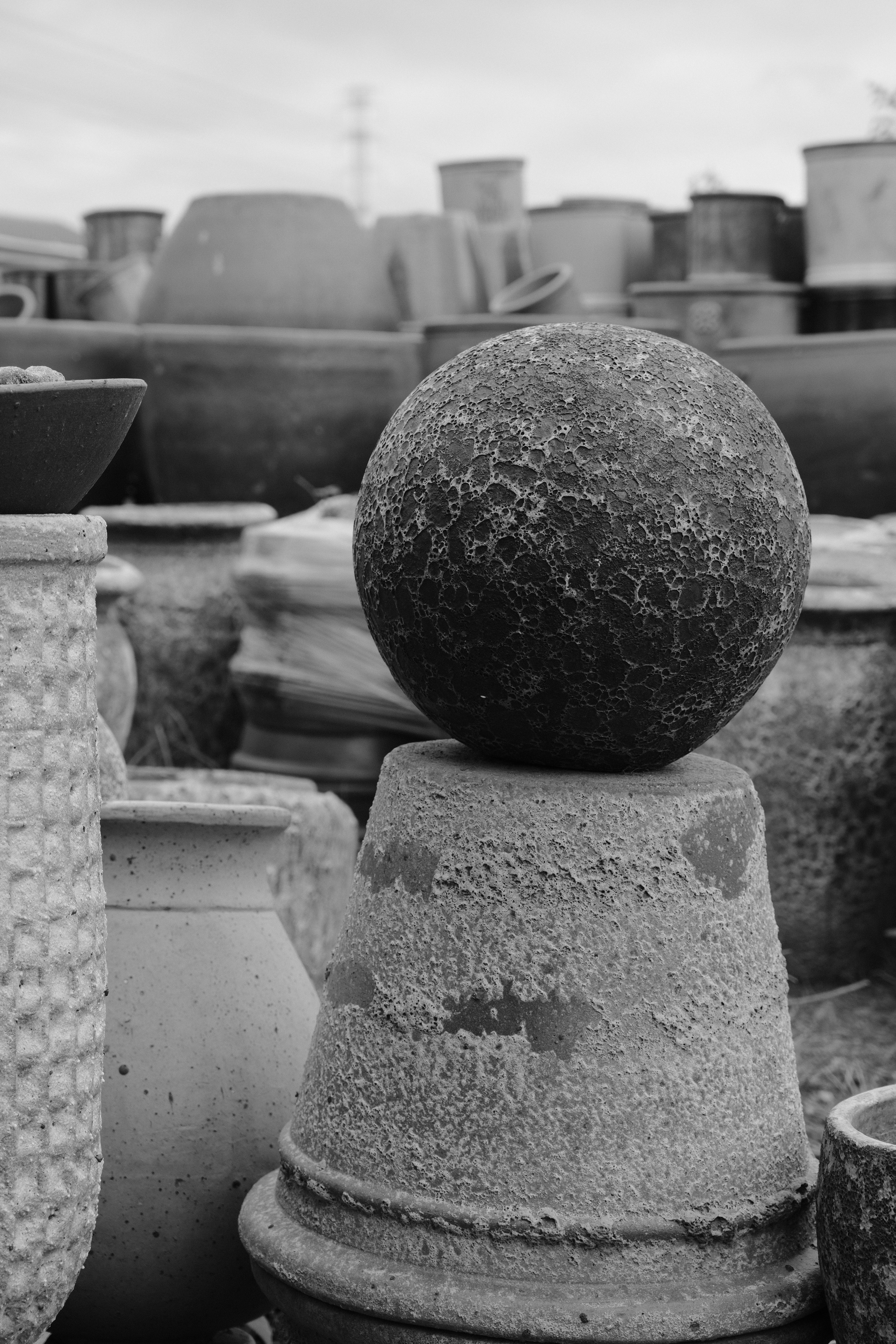 Textured Stone Pots and Sphere in Monochrome · Free Stock Photo