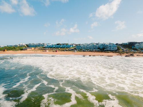 Free Aerial view of the vibrant beachfront in Punta del Este, Uruguay, showcasing waves and summer vibes. Stock Photo