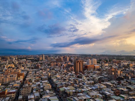 Stunning aerial shot of a sprawling cityscape under a vibrant sunset sky.