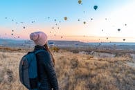 Woman Looking At Hot Air Balloons