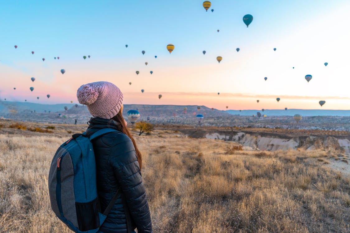 Free Woman Looking At Hot Air Balloons Stock Photo