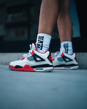 Close-up of stylish sneakers worn outdoors on a city street.