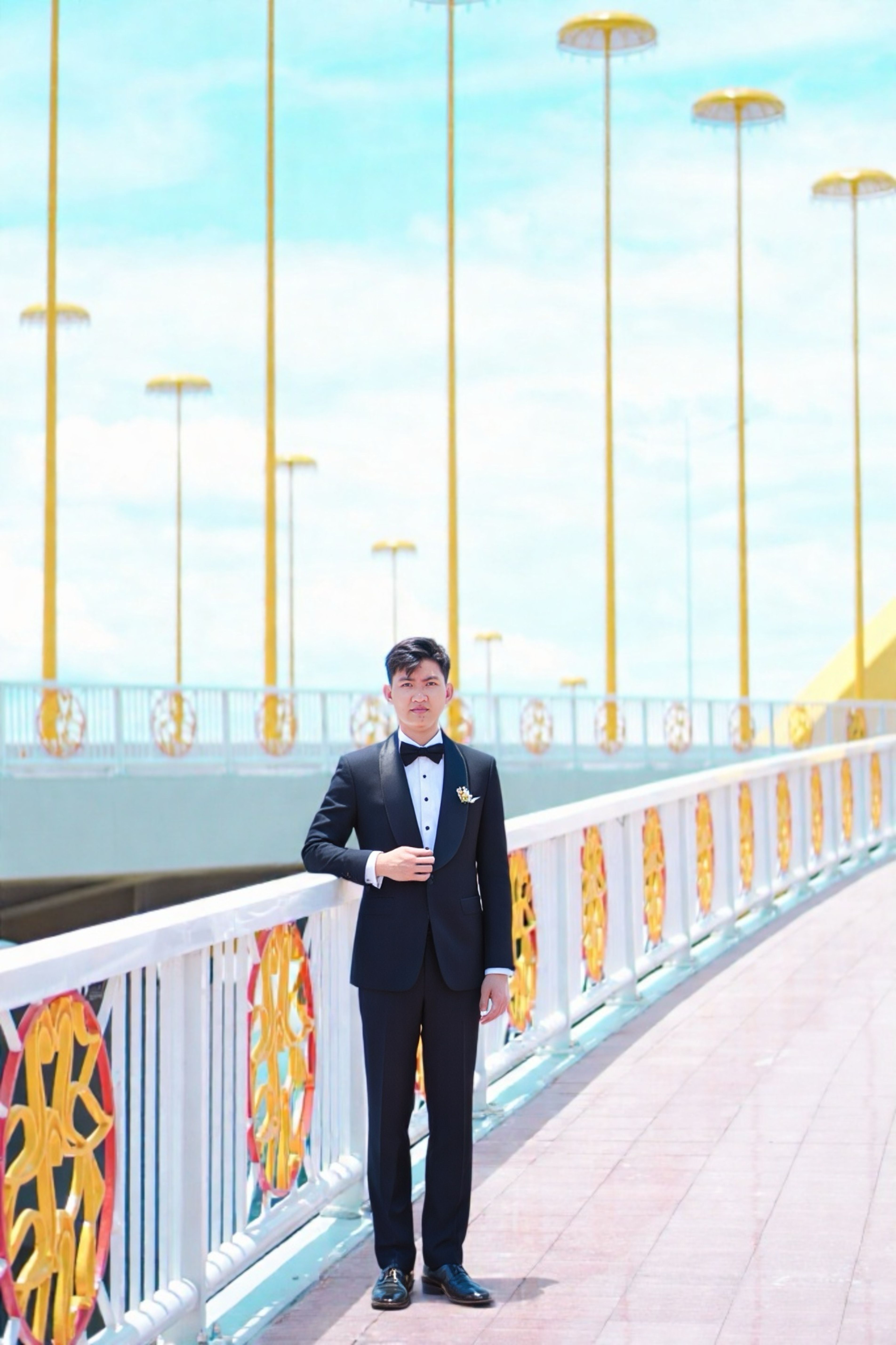 Young Man in Formal Suit on Vibrant City Bridge · Free Stock Photo