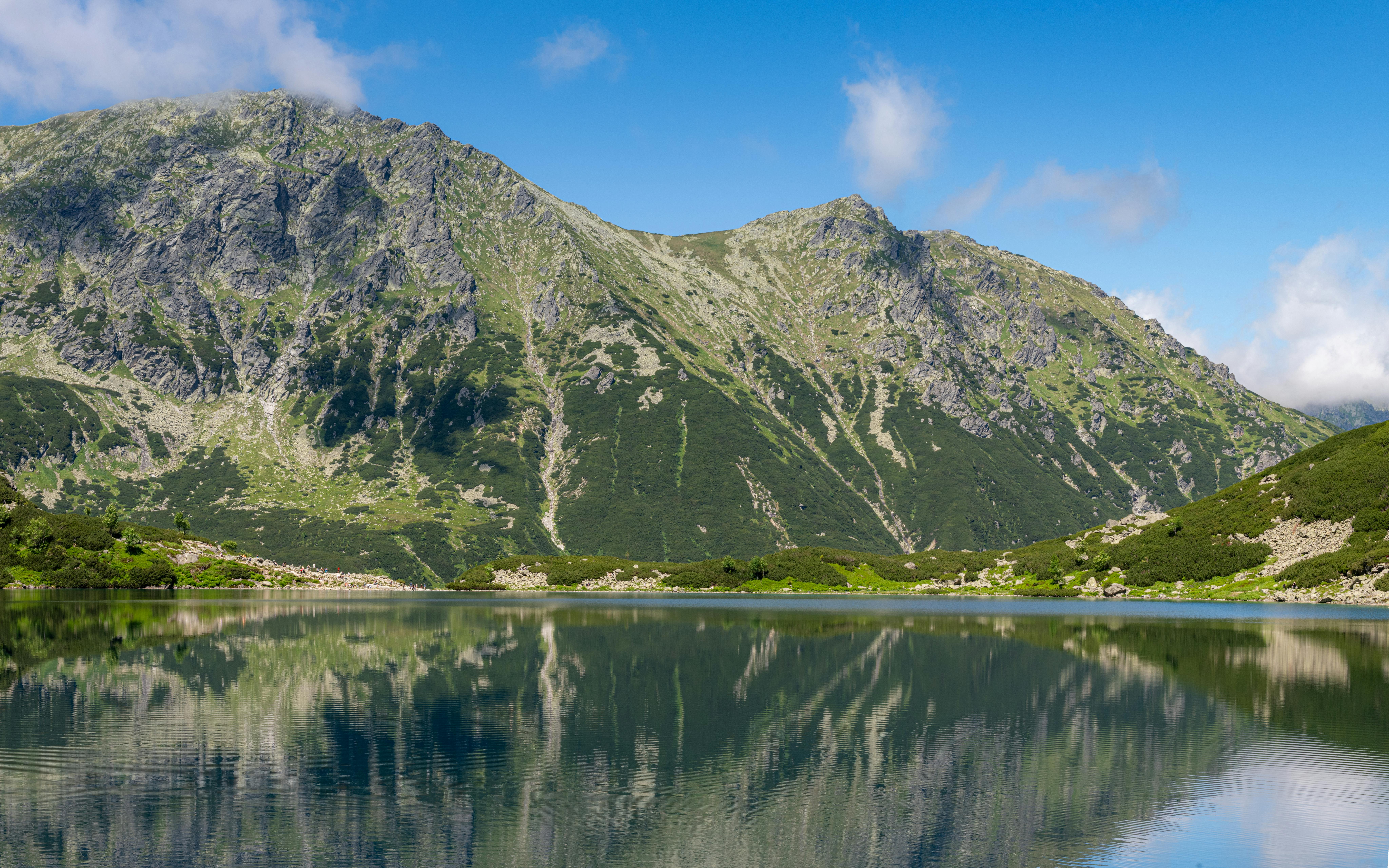 Serene mountain lake with stunning reflections in Zakopane, Poland.