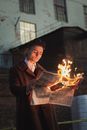 Man Reading Burning Newspaper
