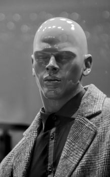 Close-up of a mannequin in a stylish wool blazer, showcasing fashion trends.
