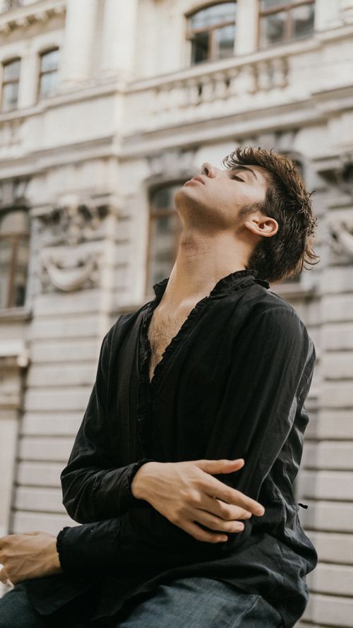 Free Elegant portrait of a young man in a black shirt against historic Istanbul architecture. Stock Photo