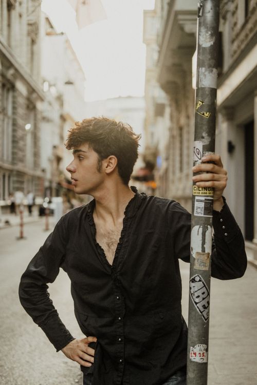 Free Stylish young man in black shirt posing on a street in Istanbul, Türkiye. Stock Photo