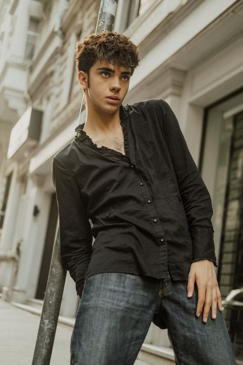 Free Stylish young man in a black shirt poses on the streets of İstanbul, showcasing urban fashion. Stock Photo