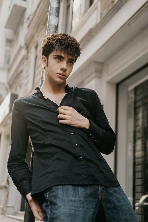 Free Portrait of a young man in a black shirt posing on a street in Istanbul, Türkiye. Stock Photo