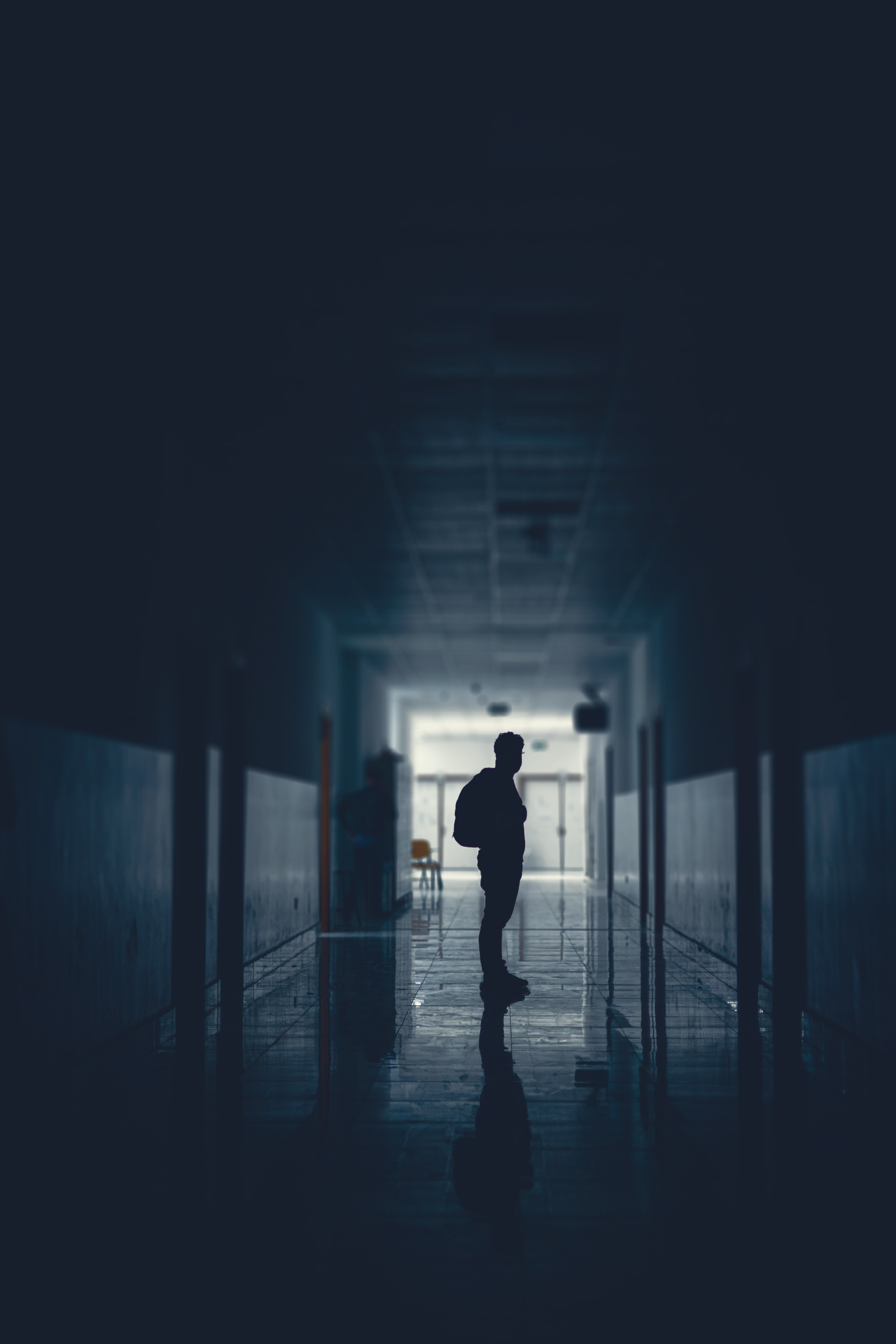 Silhouette of People Walking in a Hall in the Dark · Free Stock Photo