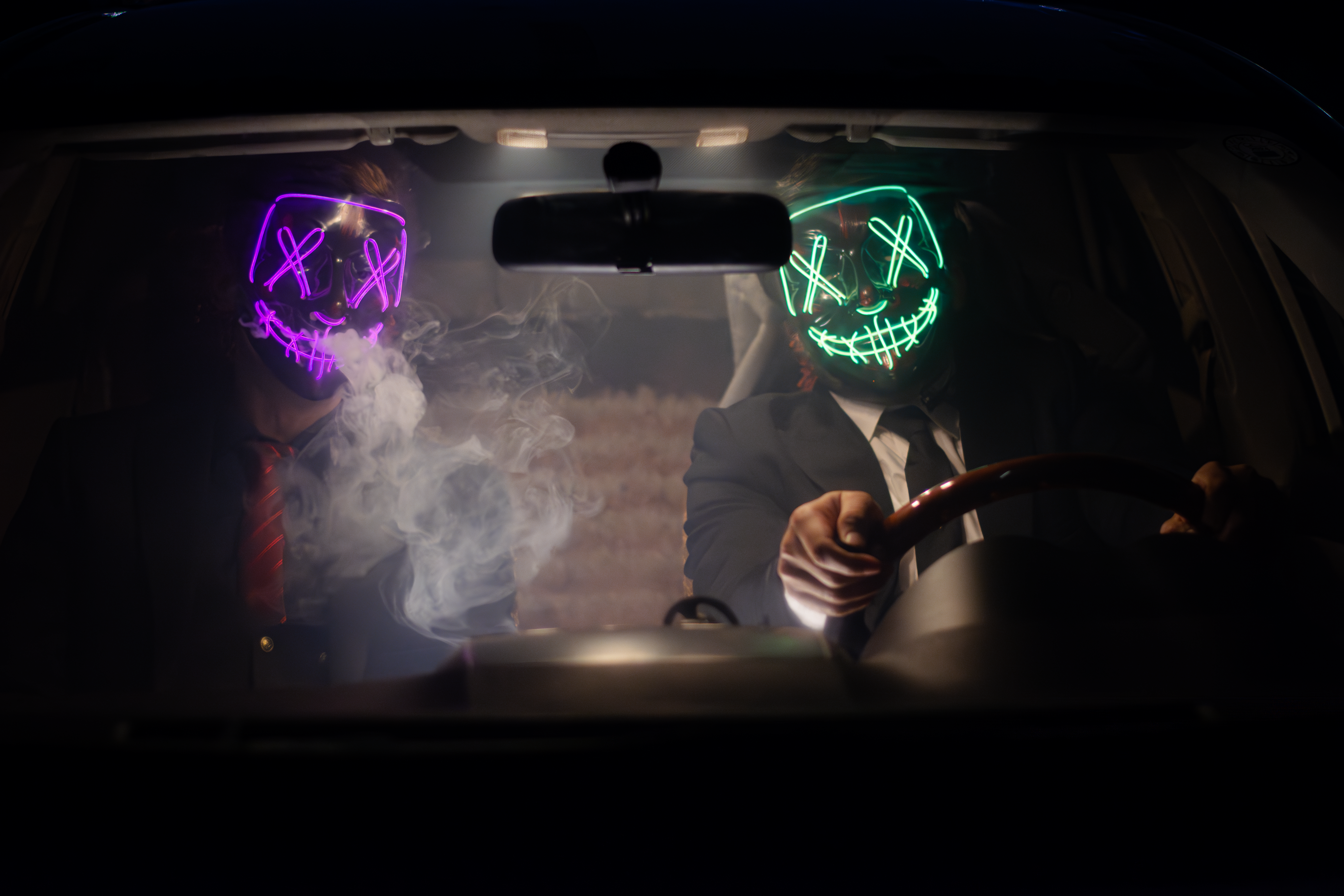 Mysterious Masked Figures with LED Glow in Car · Free Stock Photo