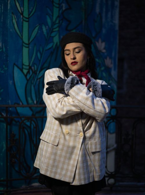 Free Chic portrait of a woman wearing a beret and coat in a cozy winter setting. Stock Photo
