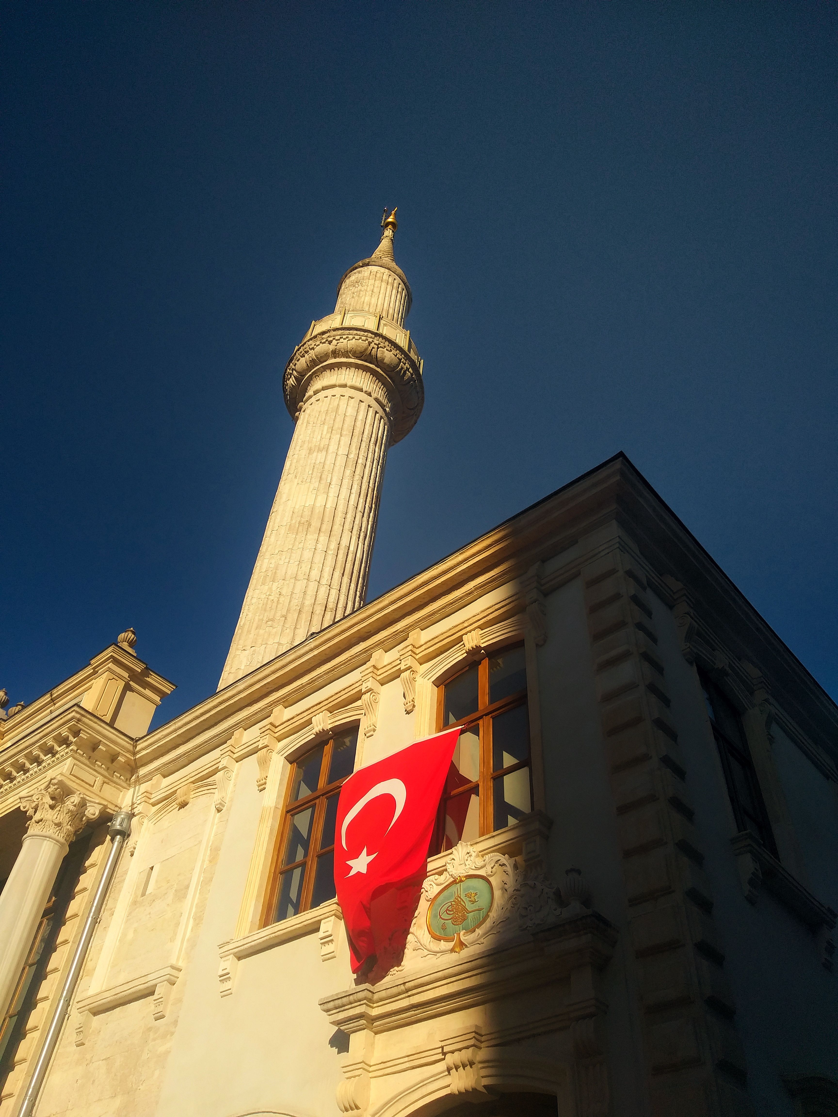 Historic Istanbul Building with Turkish Flag and Minaret · Free Stock Photo