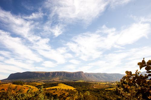 Free A breathtaking view of a mountain range with a clear blue sky and scattered clouds. Stock Photo
