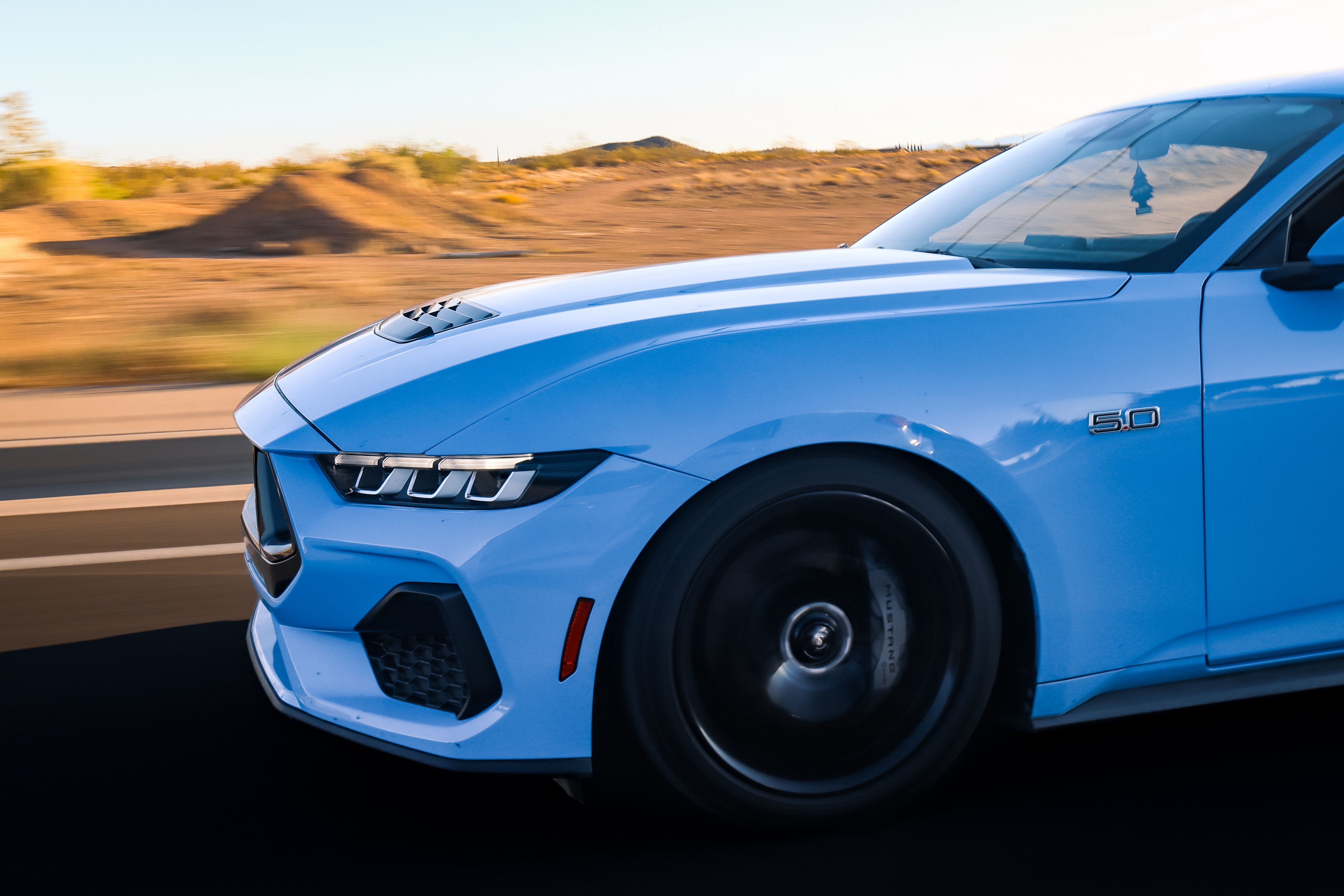 Blue Sports Car on Highway at Sunset · Free Stock Photo