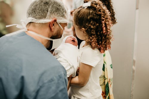 Free Man and Child Holding Baby Stock Photo