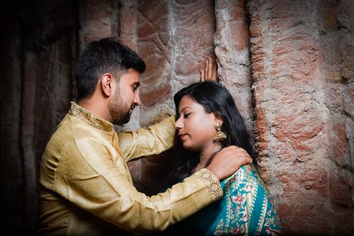 Free A couple in traditional attire shares an intimate moment in an ancient setting. Stock Photo