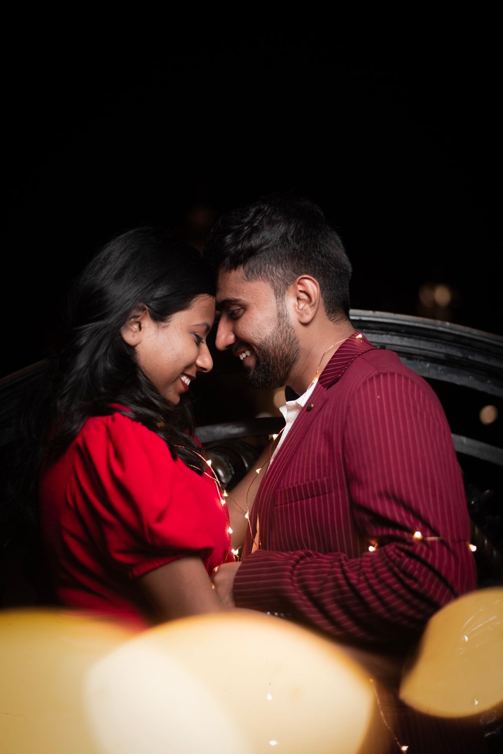 A couple shares a tender moment under soft evening lights